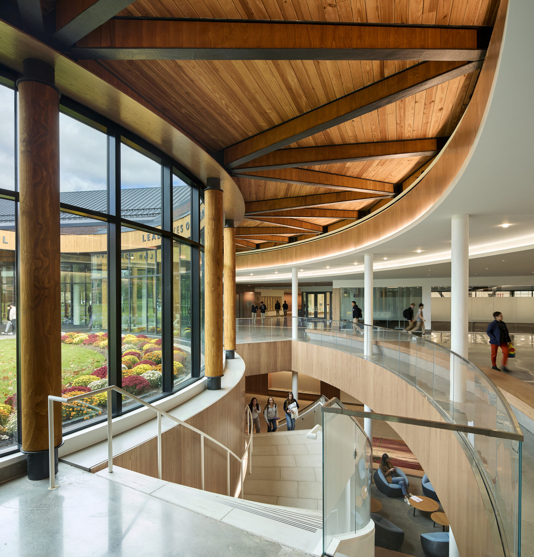 Inside the lobby, there are views down the corridor on the main level, down the stairs, and outside to the Harkness Courtyard