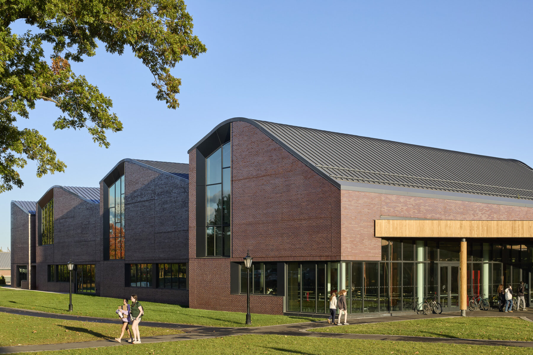 The facade of the new construction with repeated building masses with curved rooflines and large windows