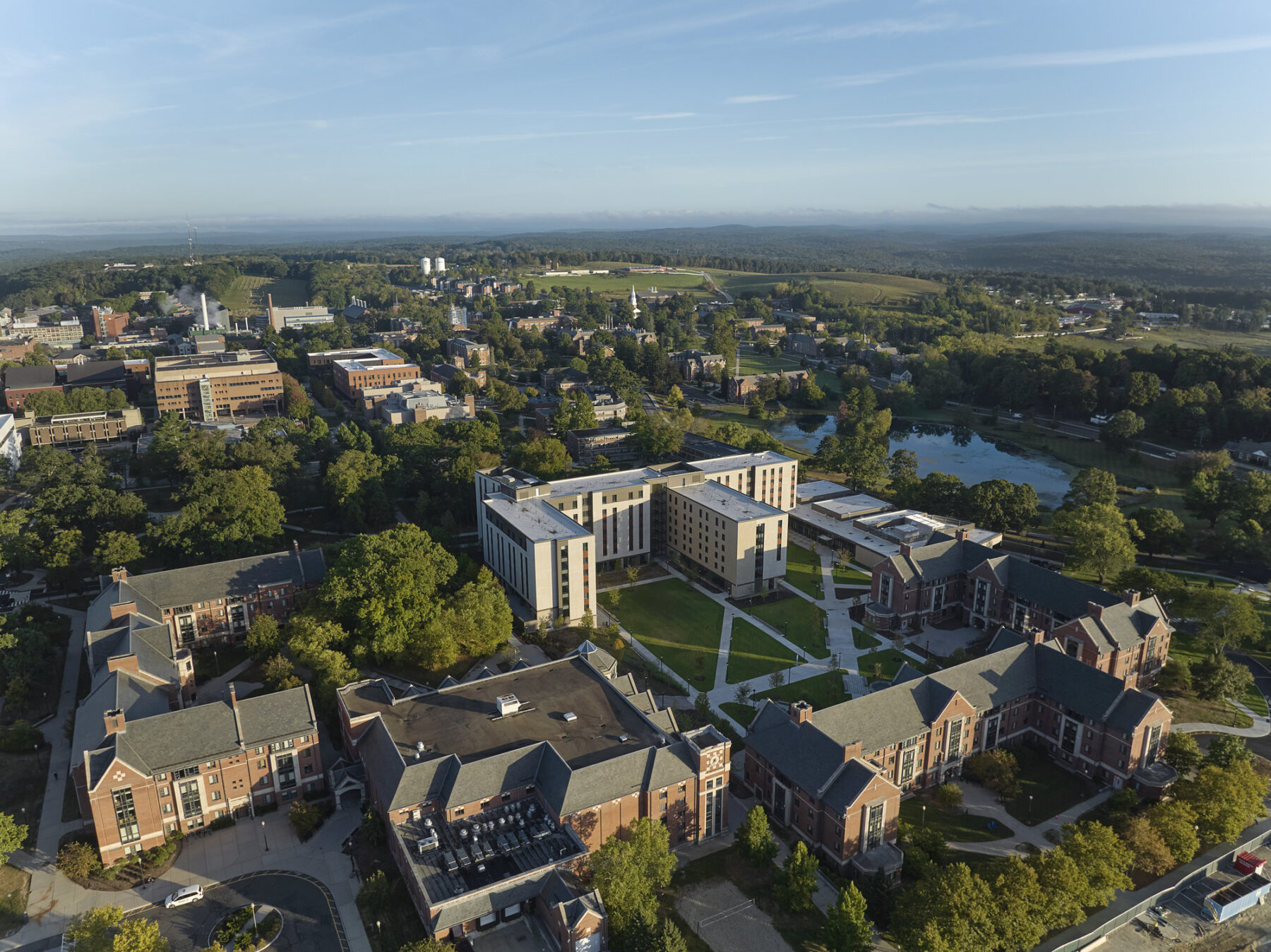 aerial photo of campus with new residential hall situated in the campus with views to Mirror Lake in the distance