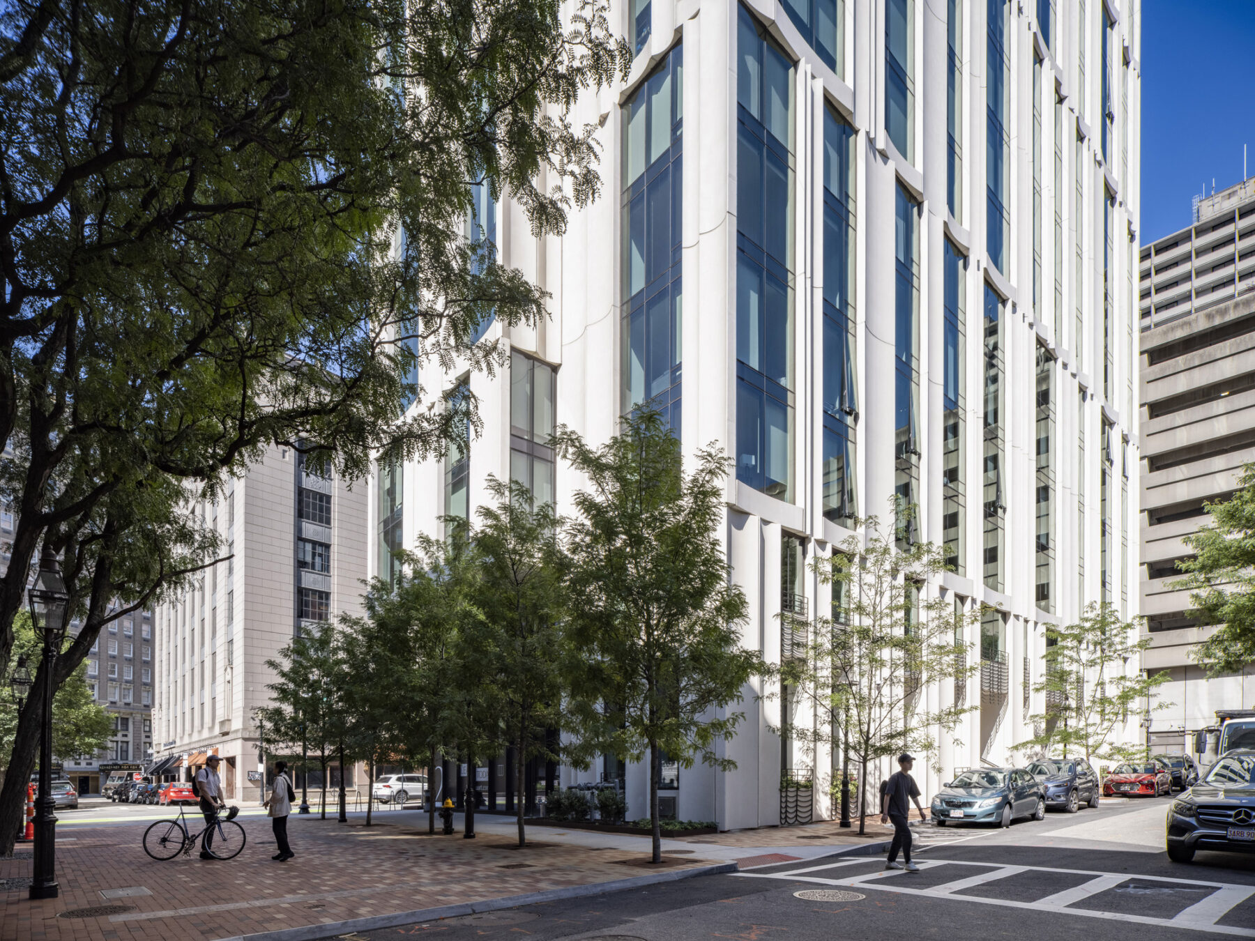 exterior photo, urban sidewalk, shade, deciduous trees
