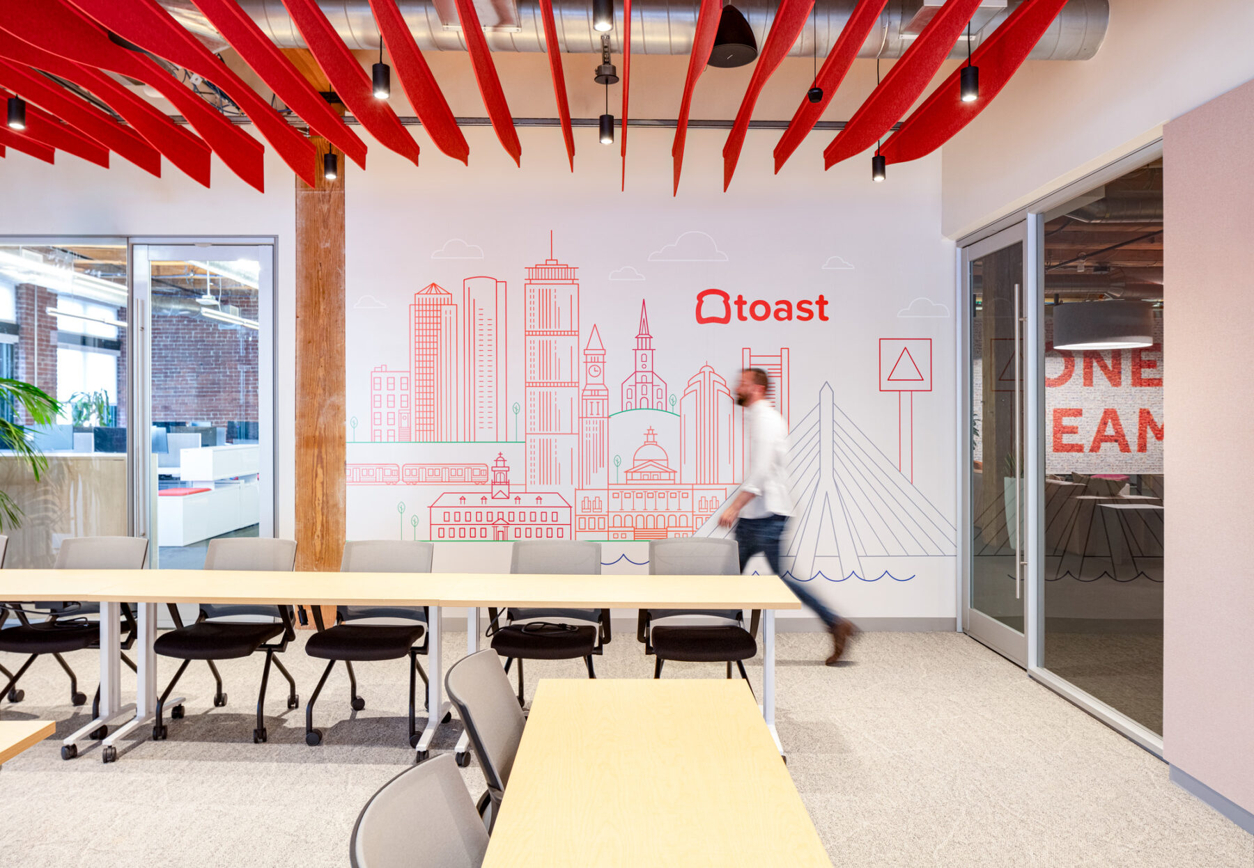 photograph of meeting room featuring custom graphic of Boston skyline