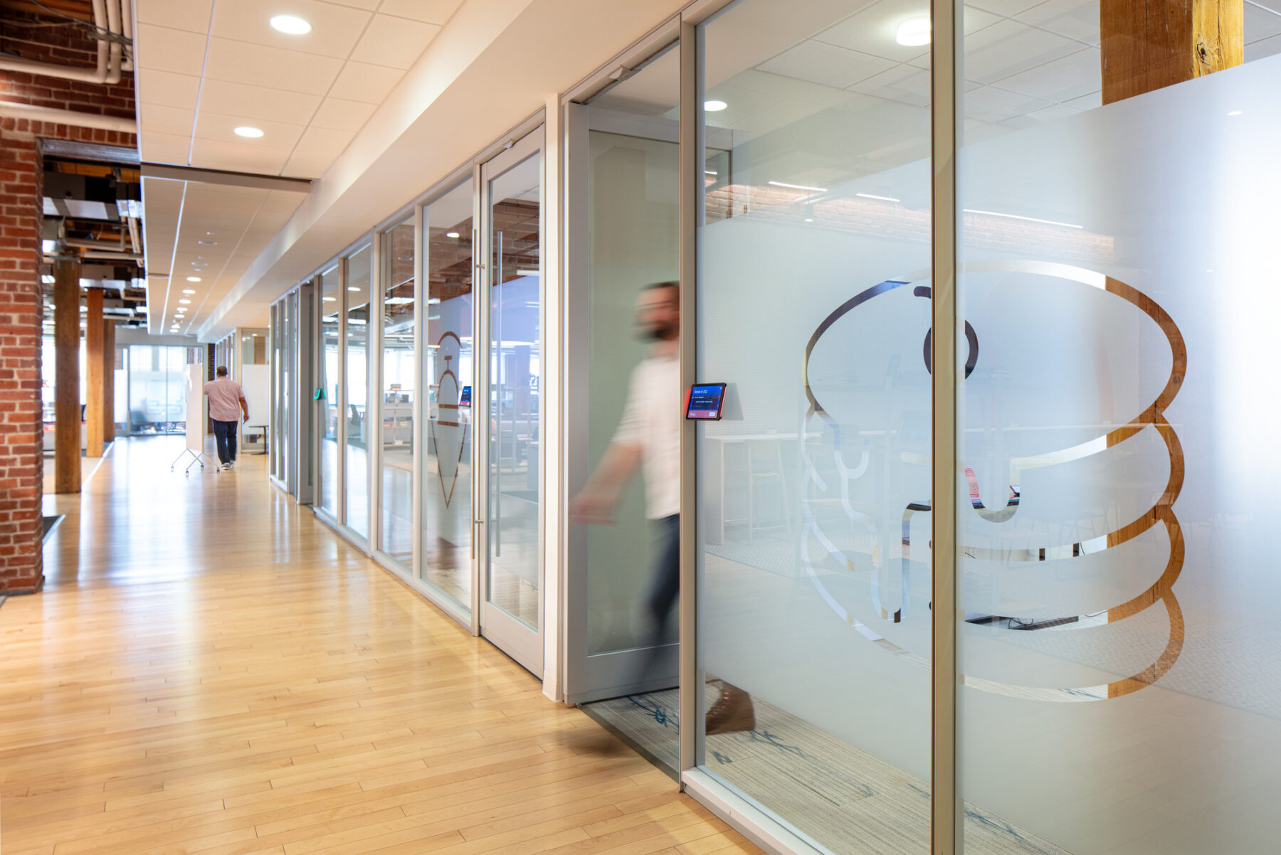 photograph of employee walking out of private meeting room