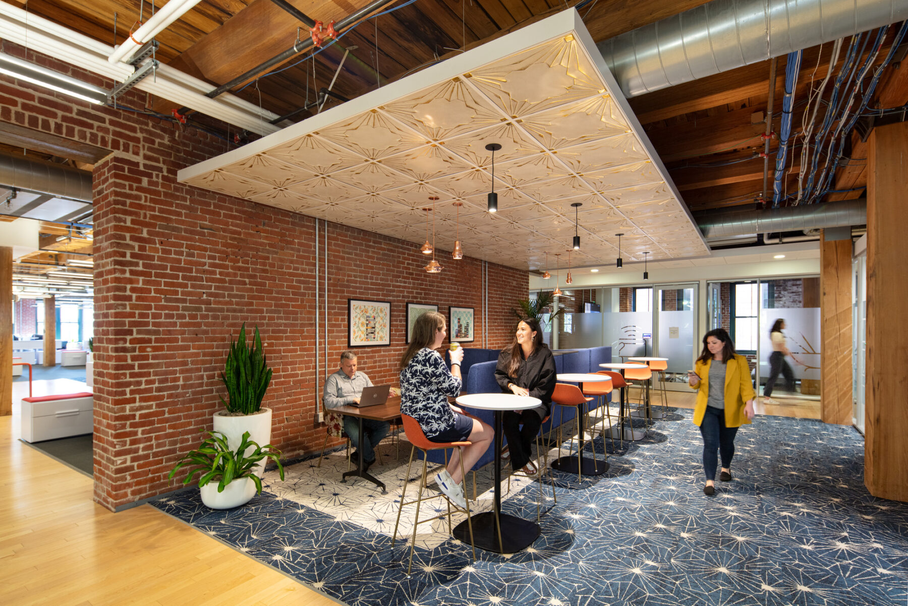 photograph of cafe space featuring high tables and a diverse material palette