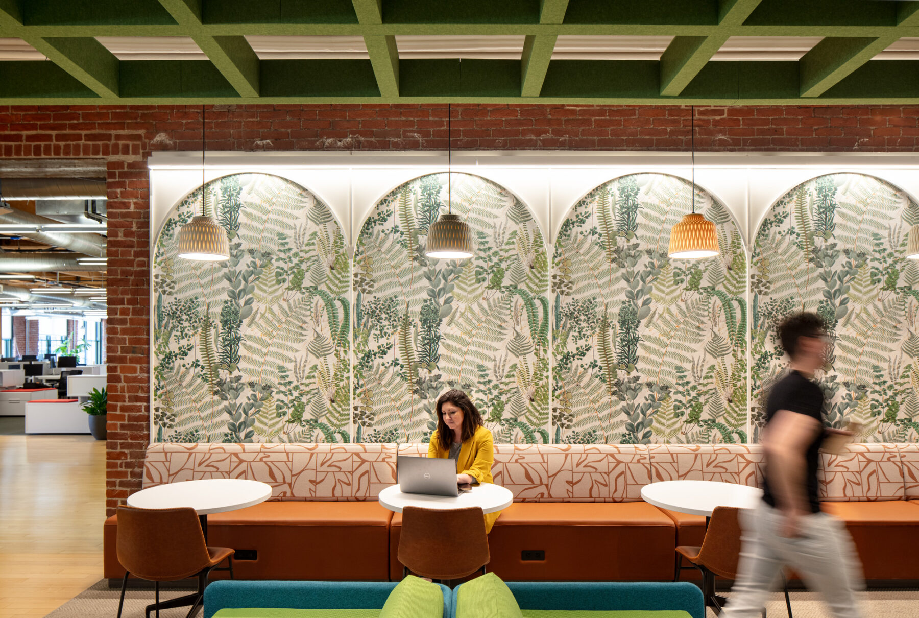 photograph of person sitting on booth of cafe space