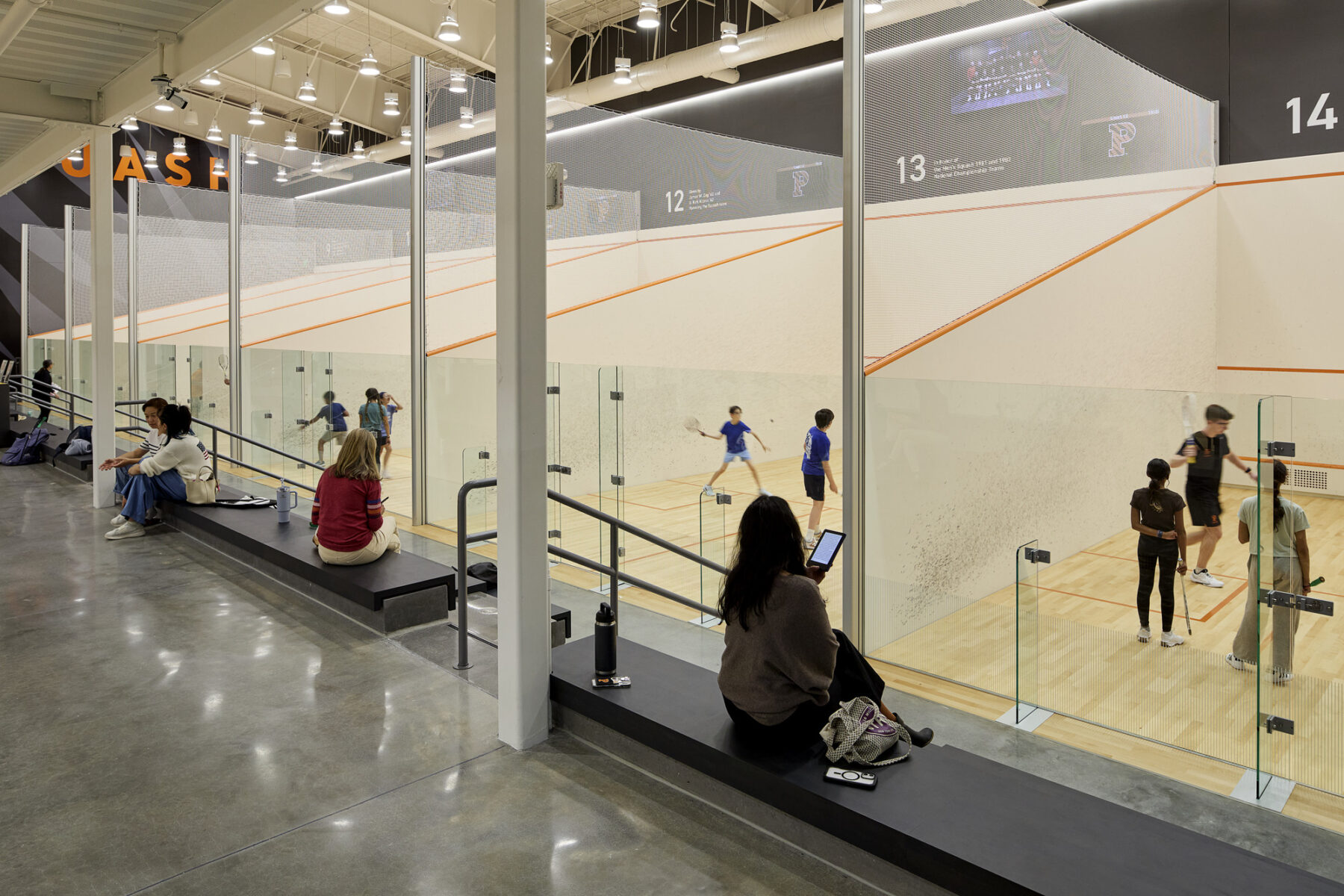 photo of squash courts with spectators on benches