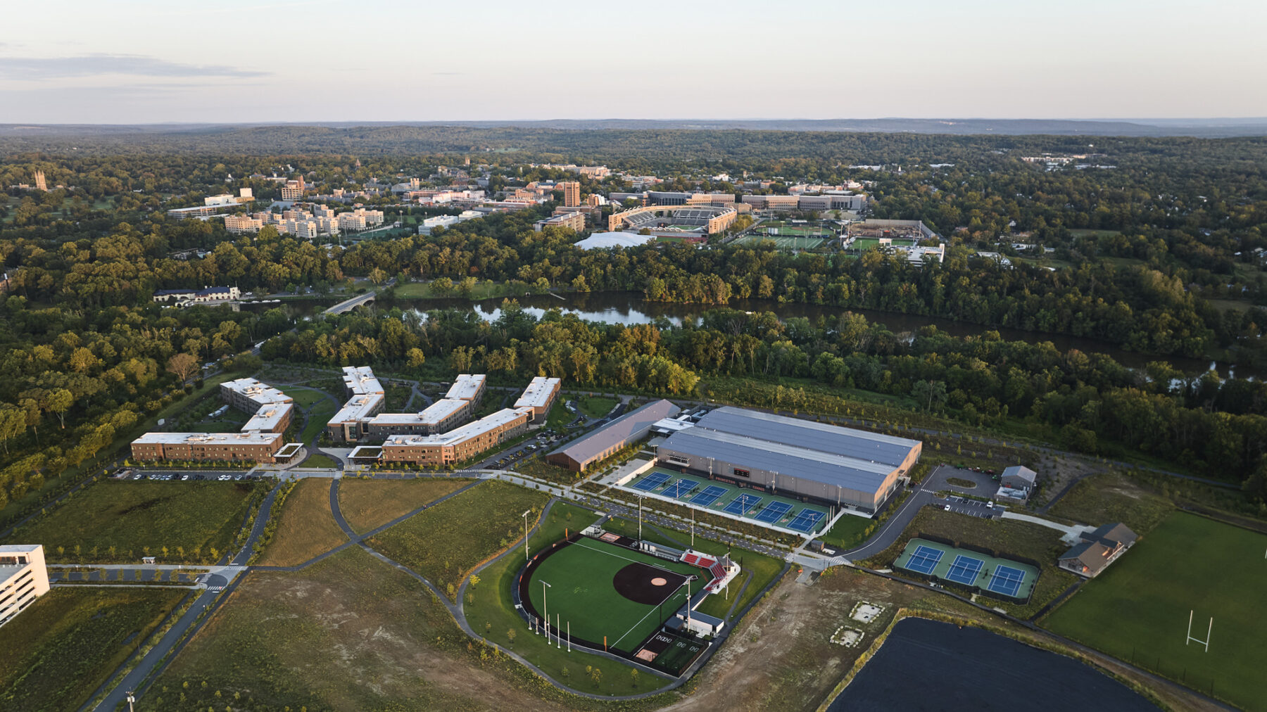 Aerial photography of new Racquet Center and campus neighborhood with campus in distance across the river