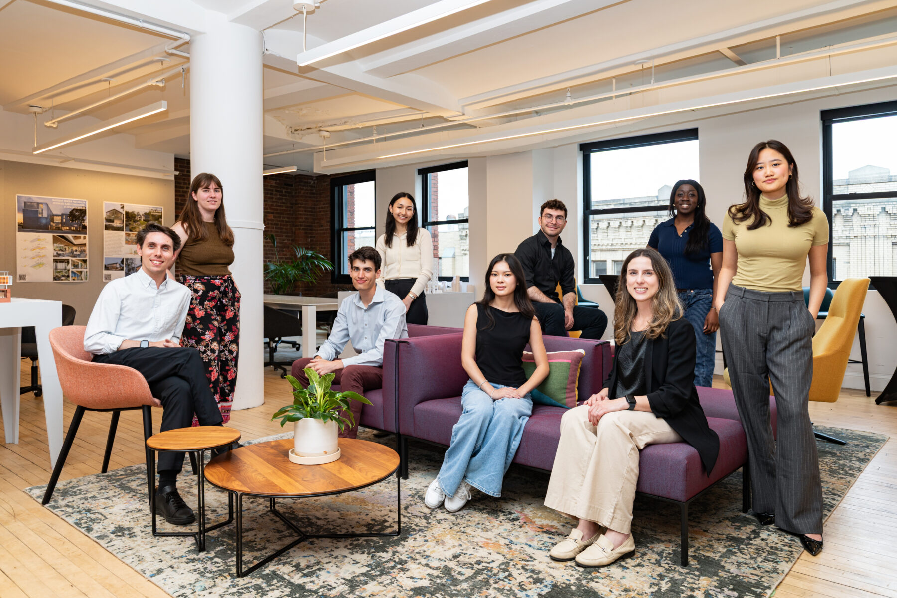 nine young people sitting around a sofa