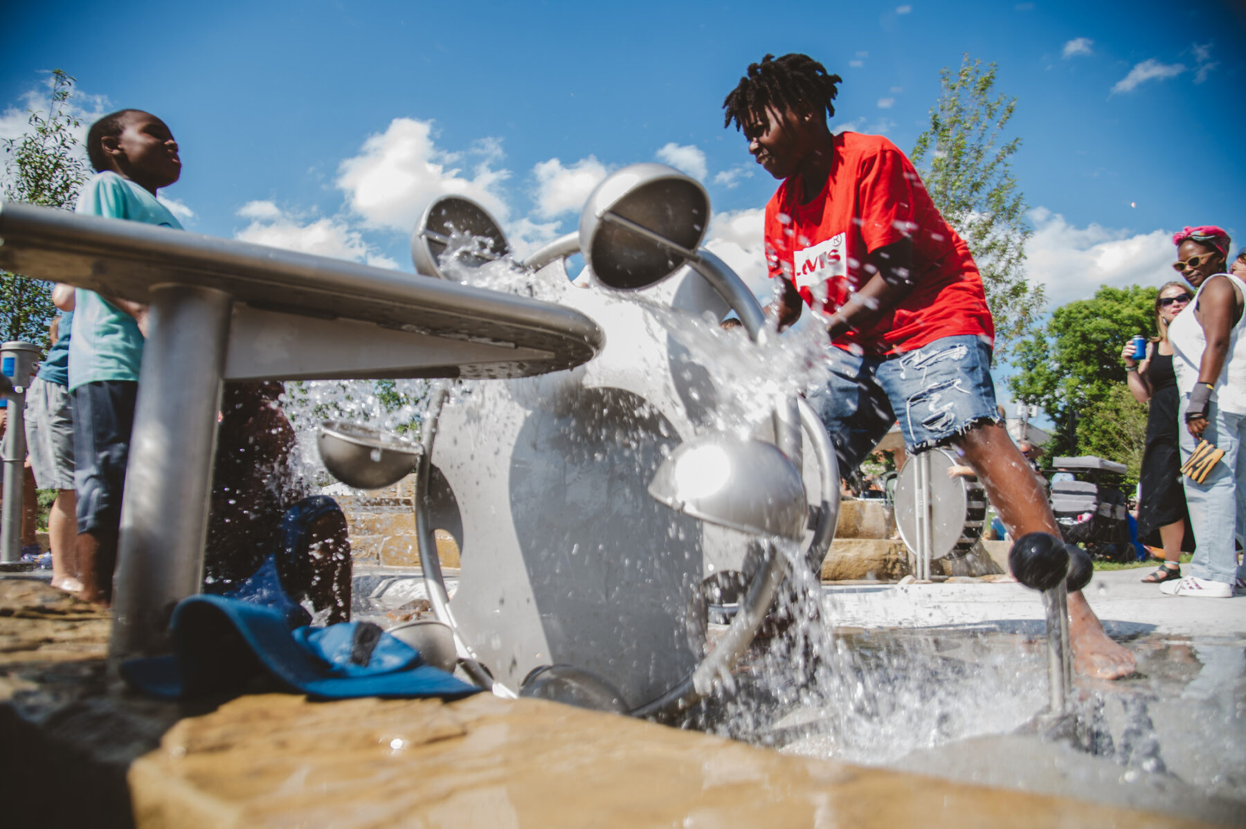photo of children playing with water fountain feature