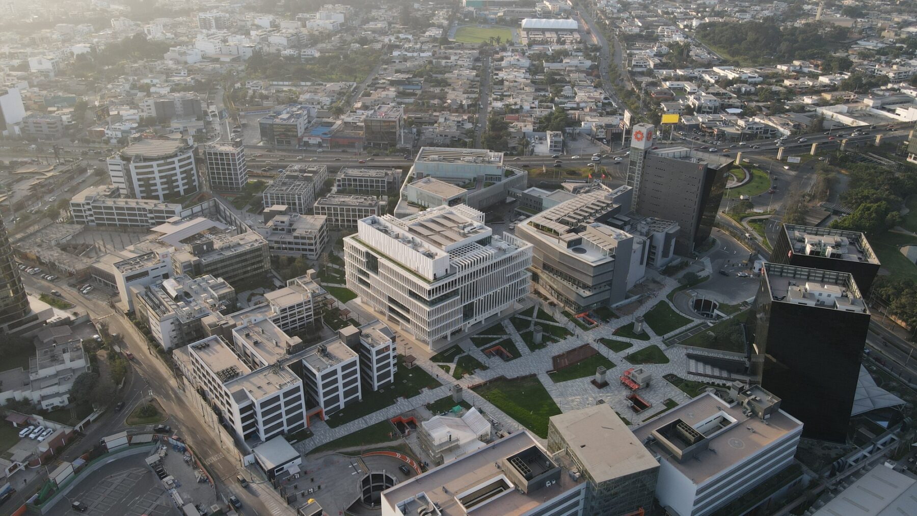 Drone view of the library in context with the campus and the city