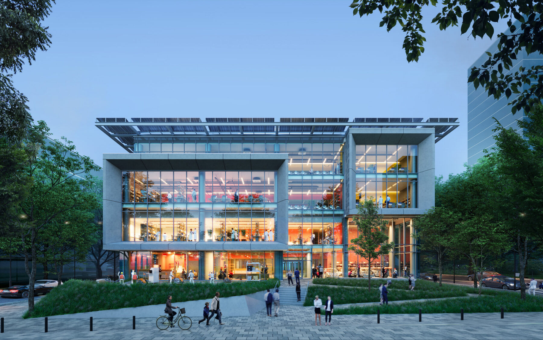Rendering of building's main facade viewed from the entry plaza at dusk with light glowing inside the curtain wall and glass openings