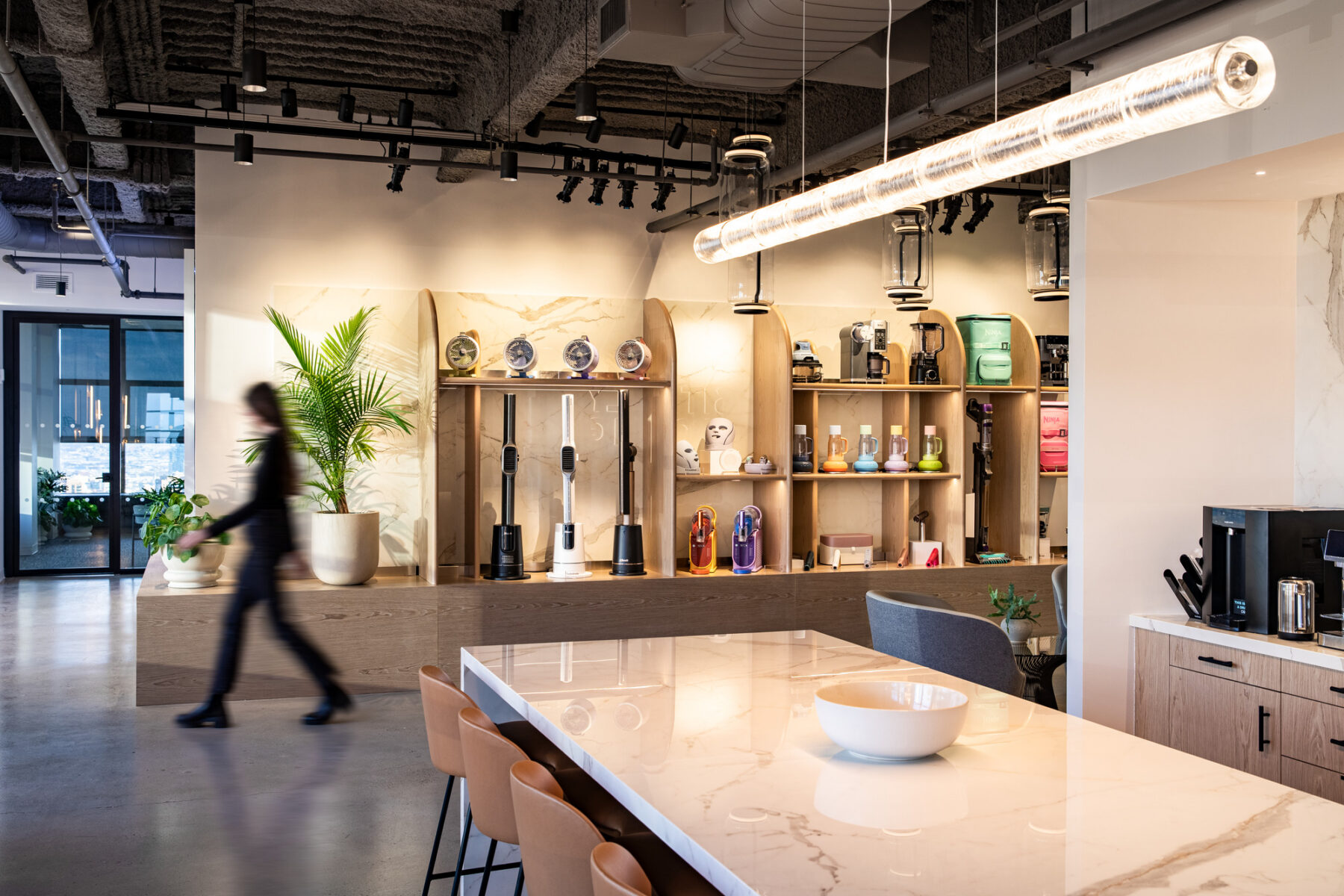 photograph of brands and products on display on a wall in the background with the kitchenette in the foreground