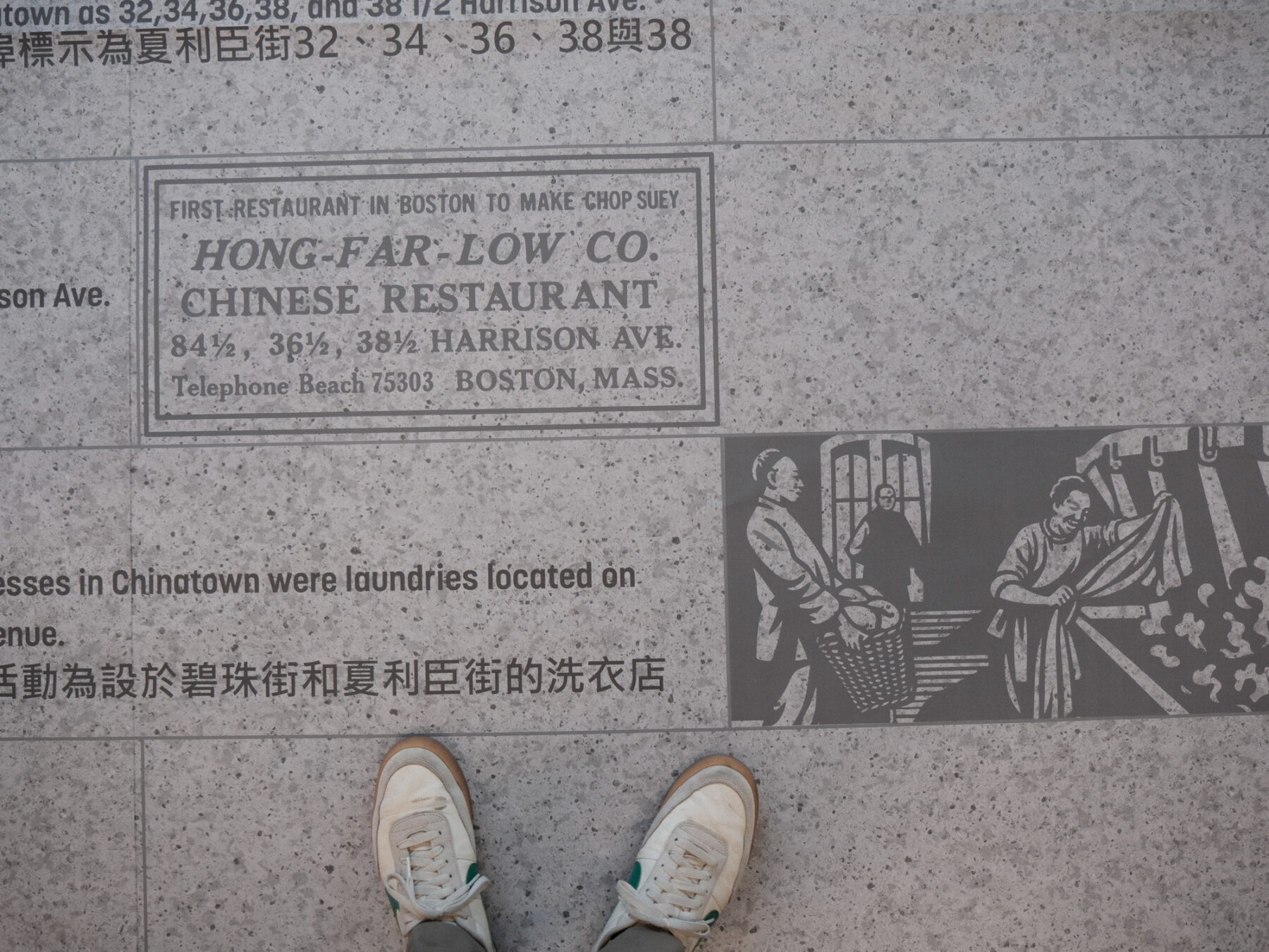 Photo of feet standing on a mock-up design of pavement