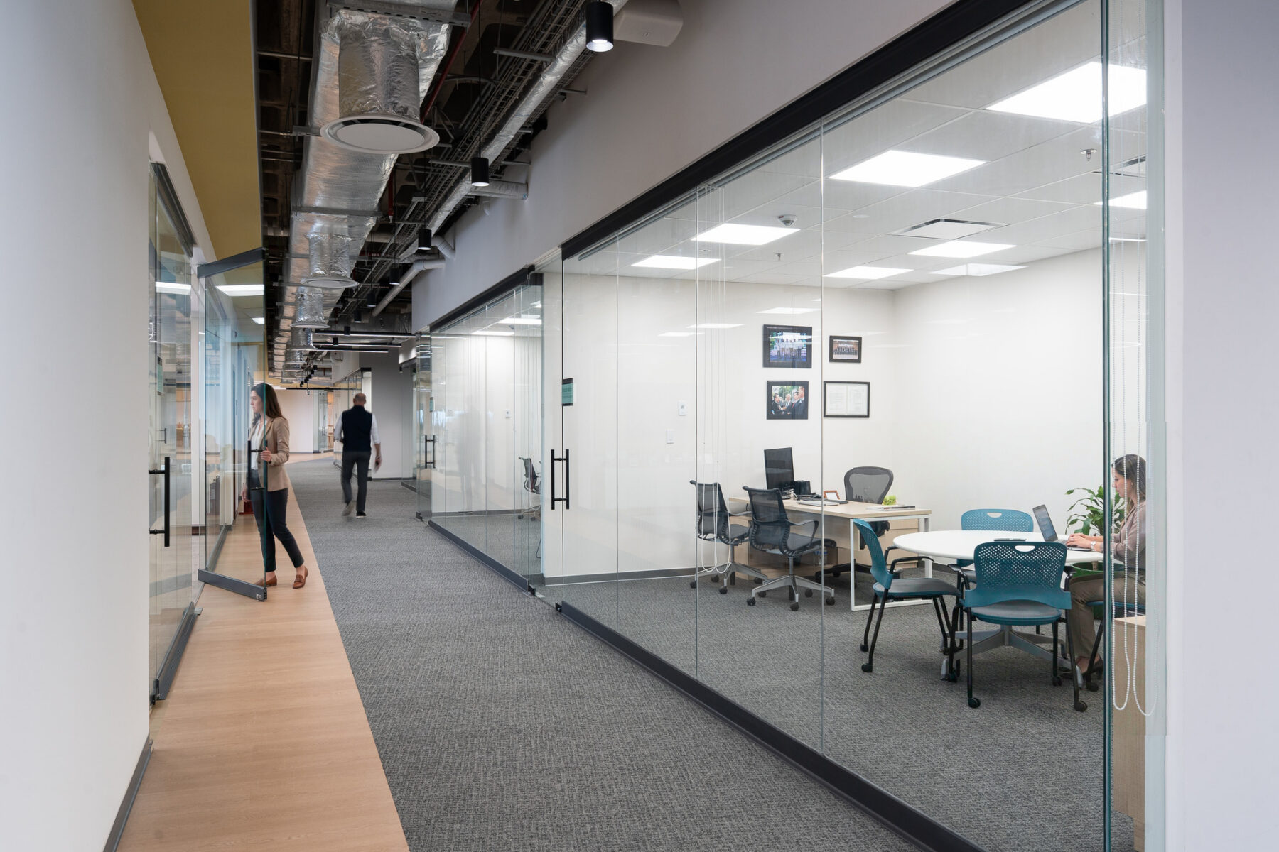 Interior photo of hallway showing storefronts looking into private offices.