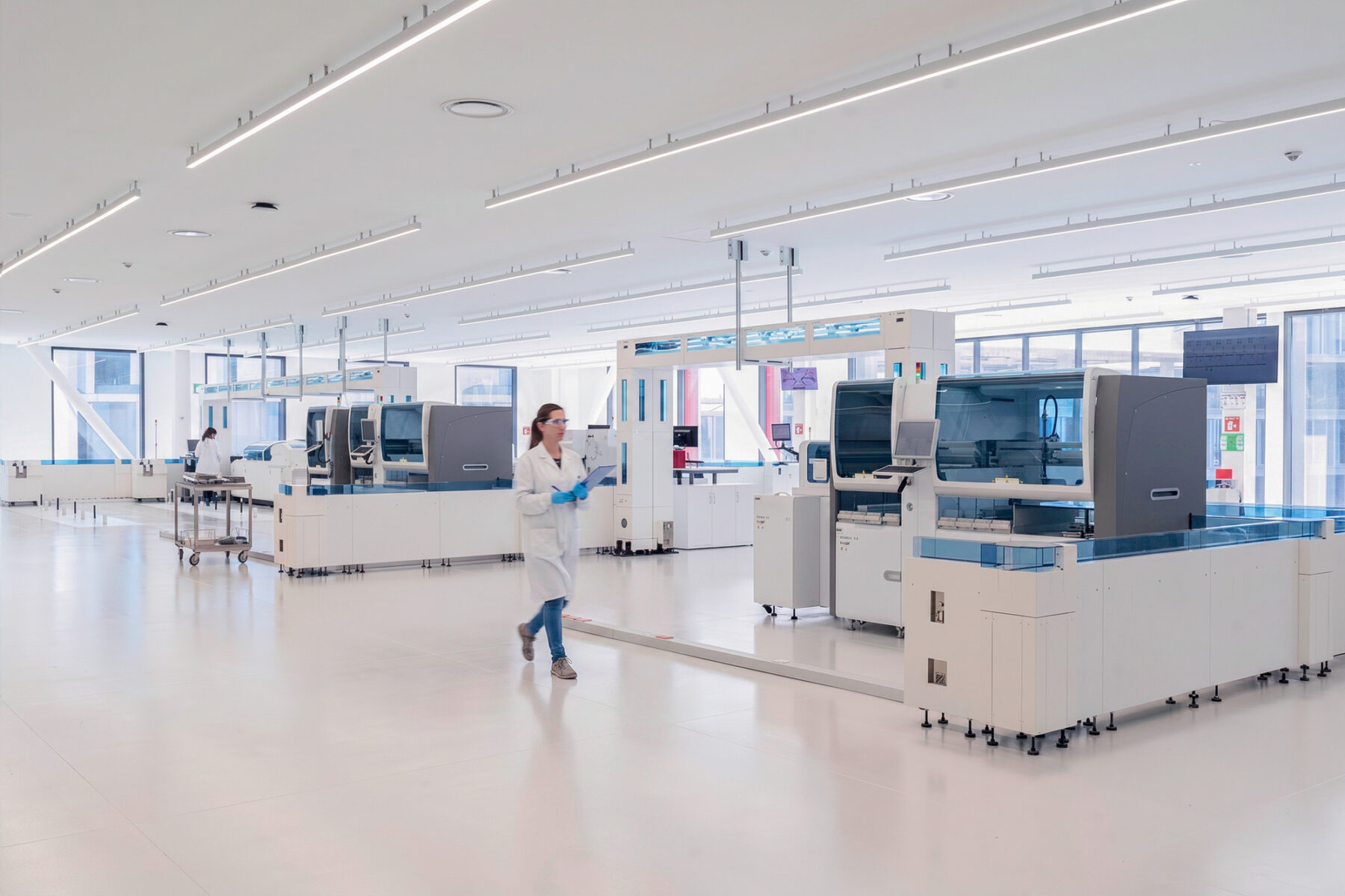 Interior photo of large laboratory with four clinical testing machinery