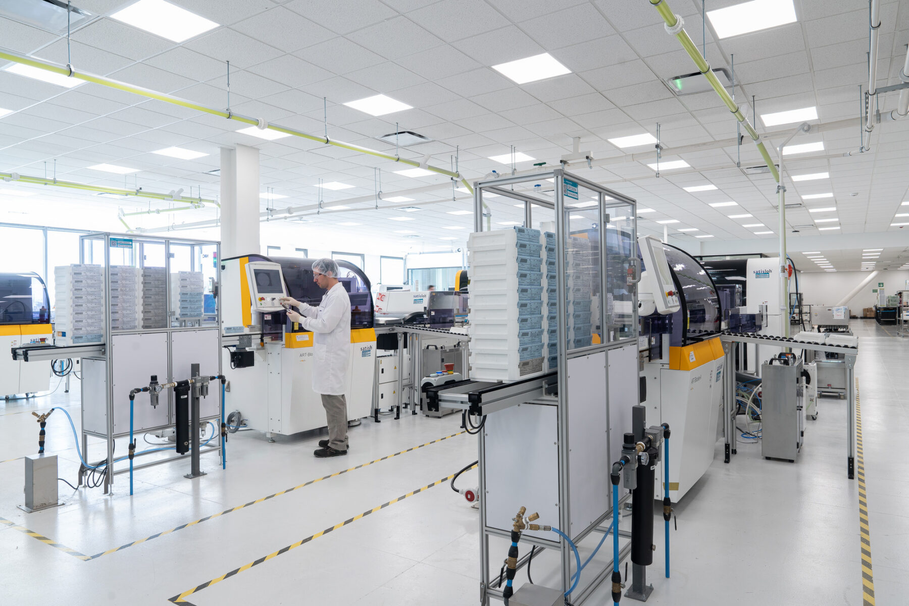 Interior photo of large laboratory with four optics machinery