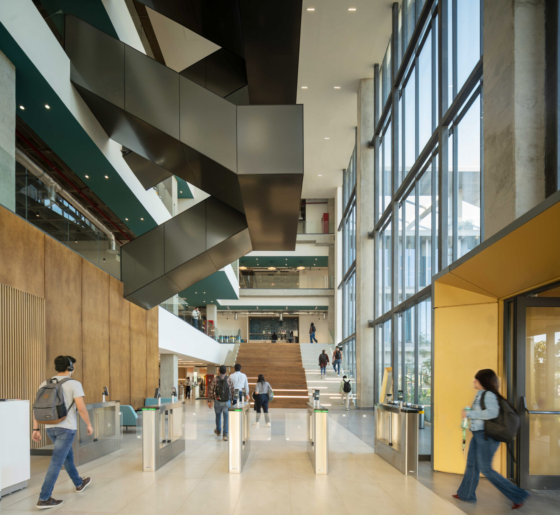 Interior photo of Salud Digna's headquarters lobby showing a triple height space and bleacher