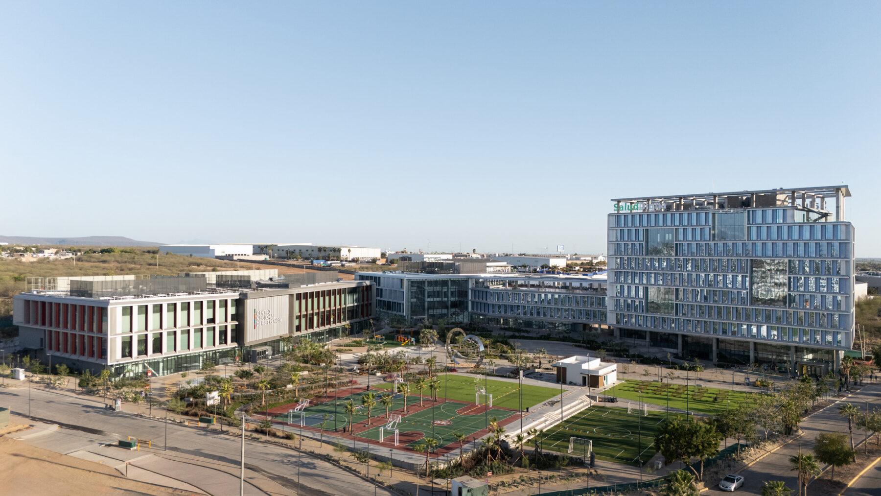 Aerial photo of Salud Digna campus phase one looking over the plaza, the headquarters and the lab building.