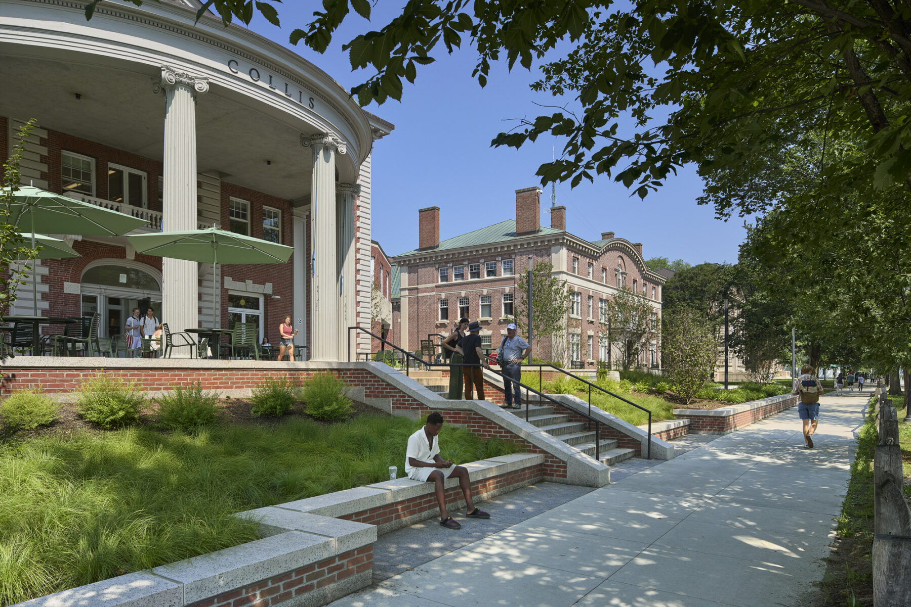 Photo after renovation showing the new stairway leading up to the porch area and Collis Center entry, connected to the sidewalk with new planting