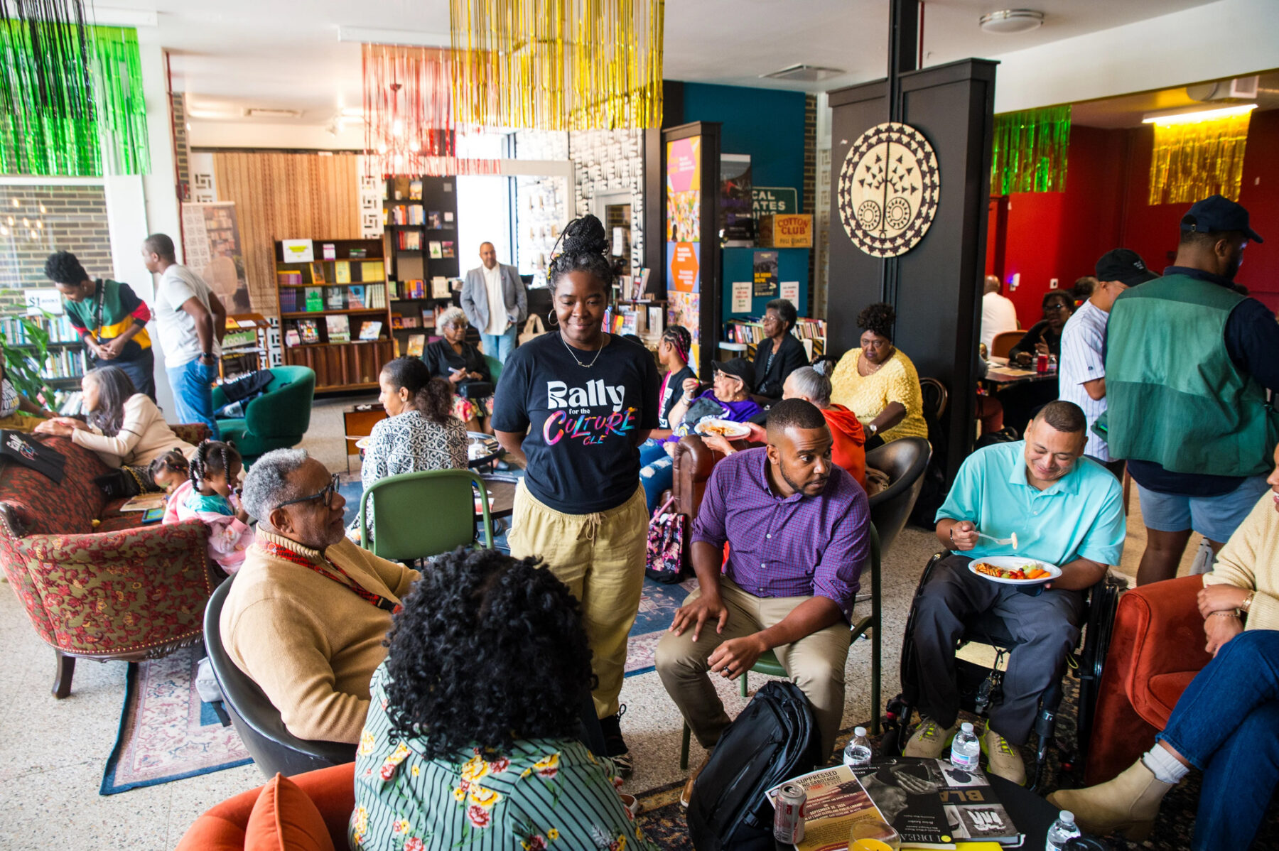 Photo of community engagement showing woman standing leading a group in a conversation