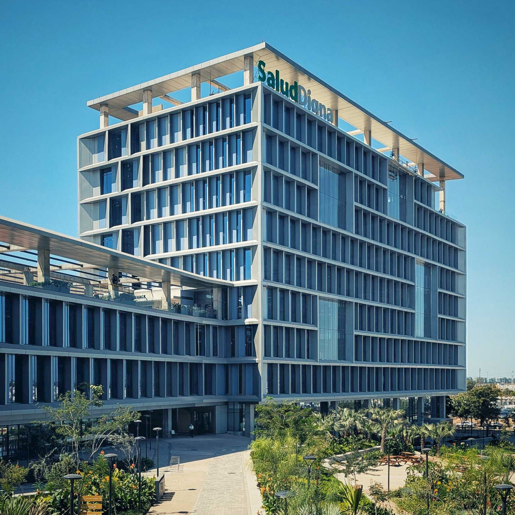 Exterior photo of Salud Digna headquarters showing the plaza and tower in broad daylight