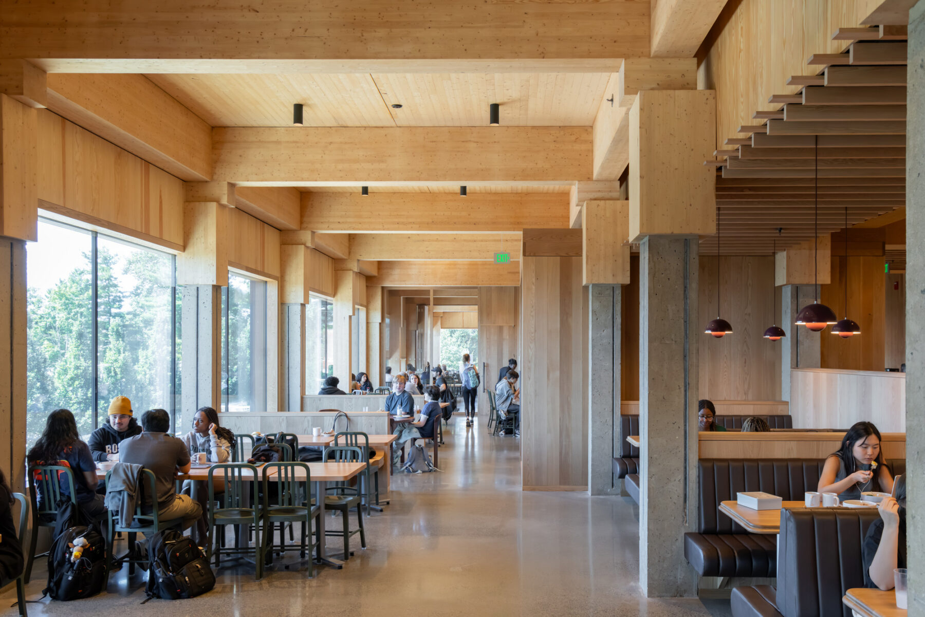 Photo of interior dining area with wood ceilings and capped concreted columns
