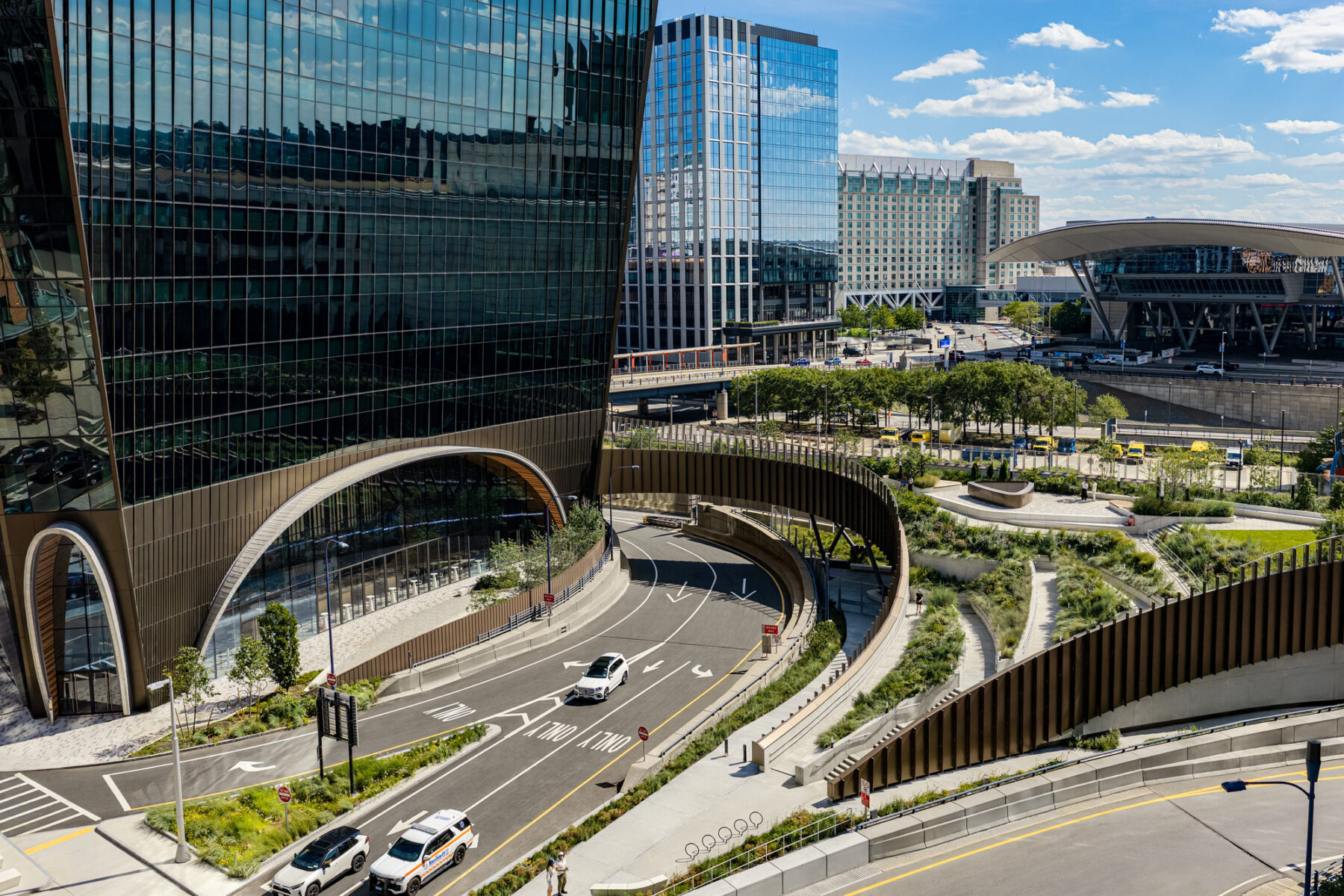 Exterior drone photo showing building and landbridge sustpended over highway and surface roads
