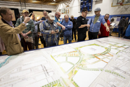 Community members check out the map of the proposed site of the new Denver Broncos Stadium during a community information meeting to inform and request input from the community on Thursday, February 12, 2026 at La Alma Recreation Center in Denver, Colorado. Photo by Gabriel Christus / Denver Broncos